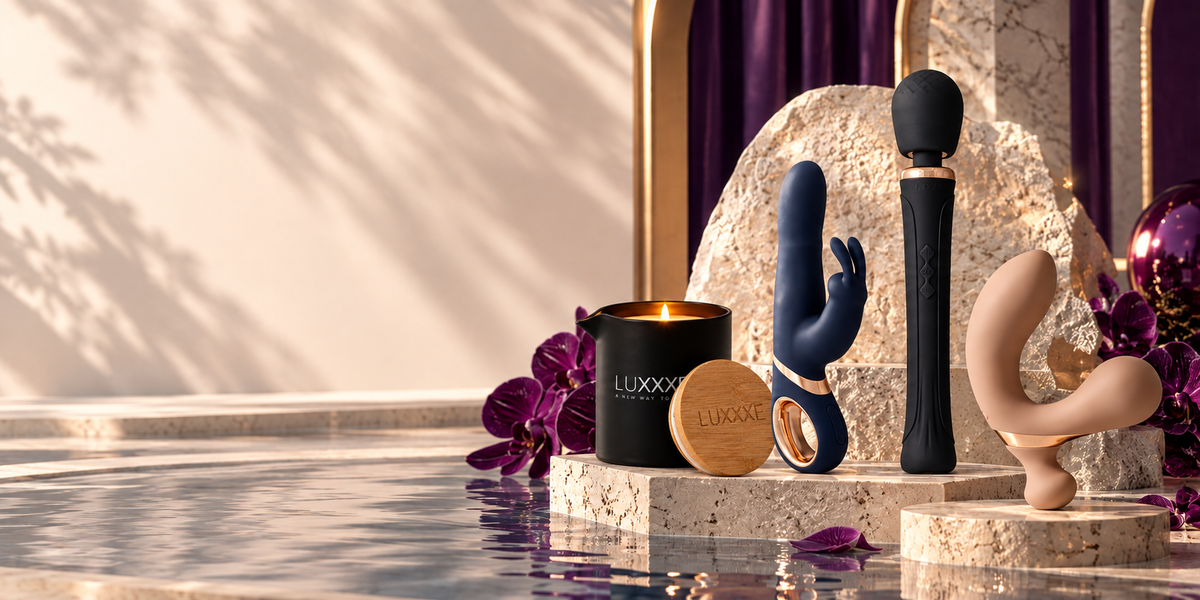 LUXXXE luxury sexual wellness products displayed in an elegant cream, purple and gold setting