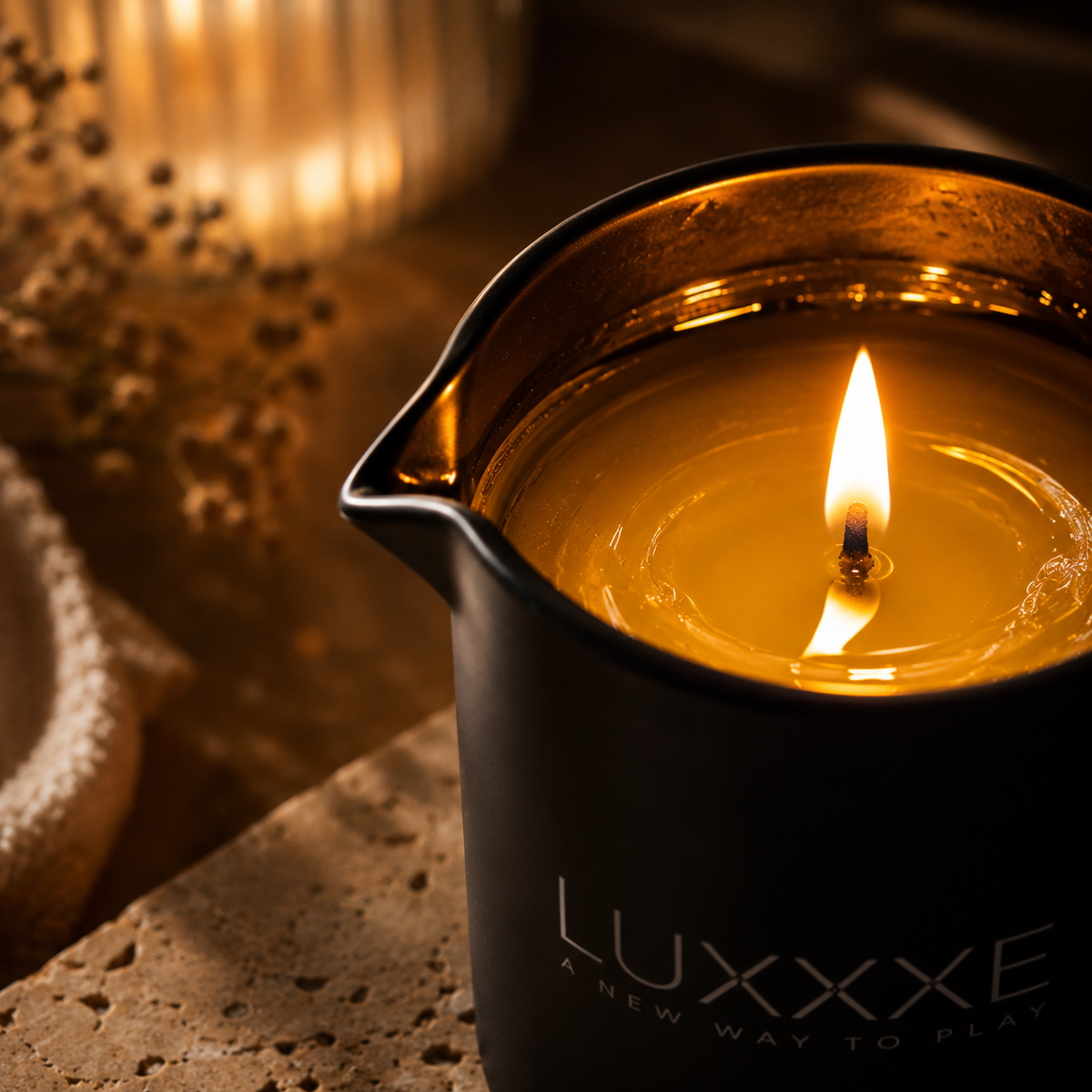 LUXXXE Aura massage oil candle creating a warm relaxing ambiance